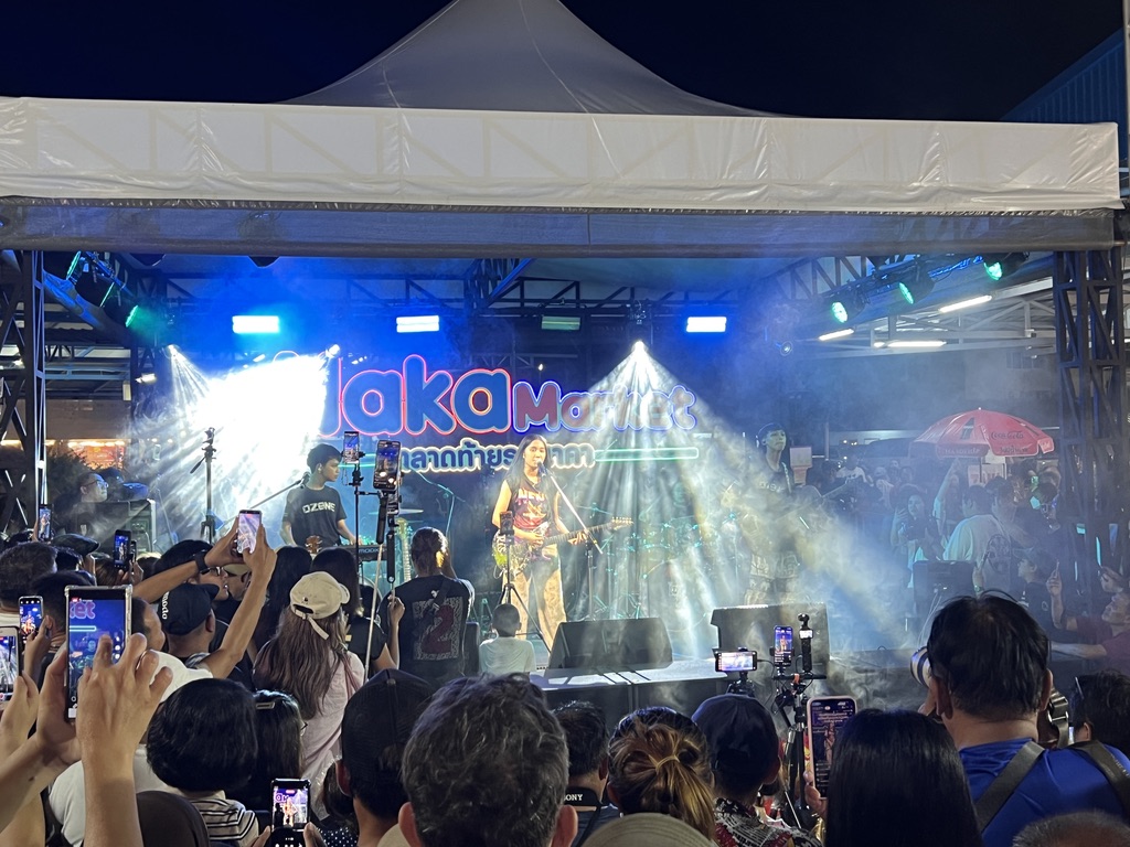 Live music on stage at a Thai night market — modern Thailand